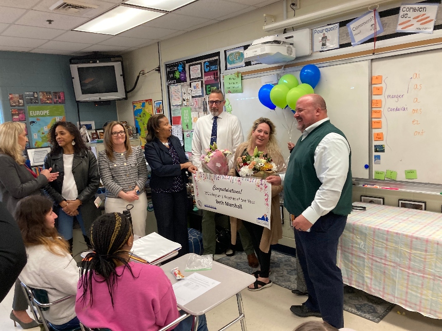 Beth Marshall, center, a French teacher at Riverbend High School, was named Teacher of the Year for Virginia Region 3 in a surprise announcement on Friday, April 5. Photo by Adele Uphaus.