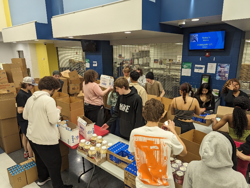 Stafford High School students package meal kits to distribute to fellow students over spring break.